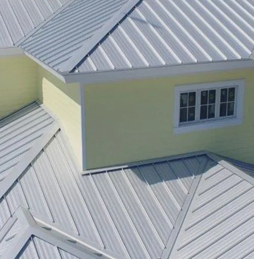 Standing seam roof panels around a dormer