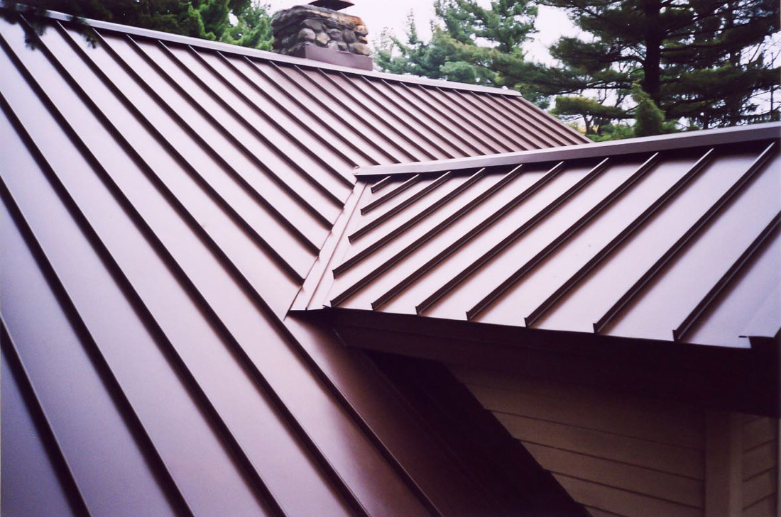 Snap-lock standing seam metal roof panels on a house